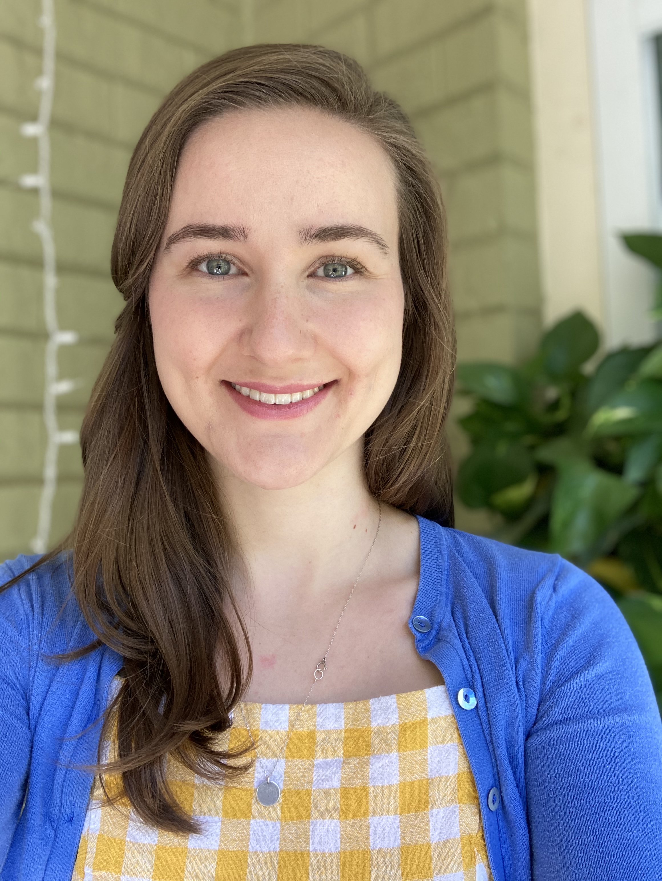 smiling woman with brown hair in a blue sweater